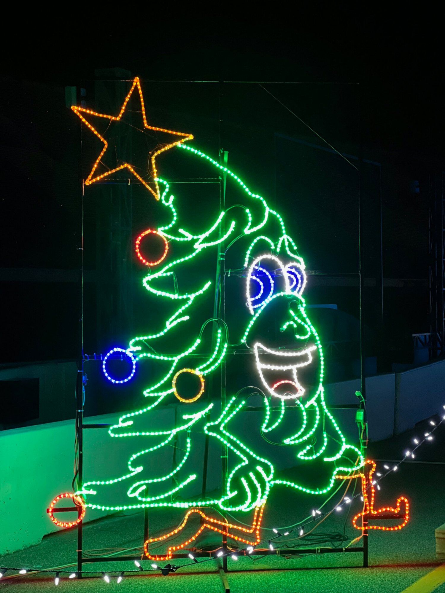 Neon Christmas tree display glowing on the route