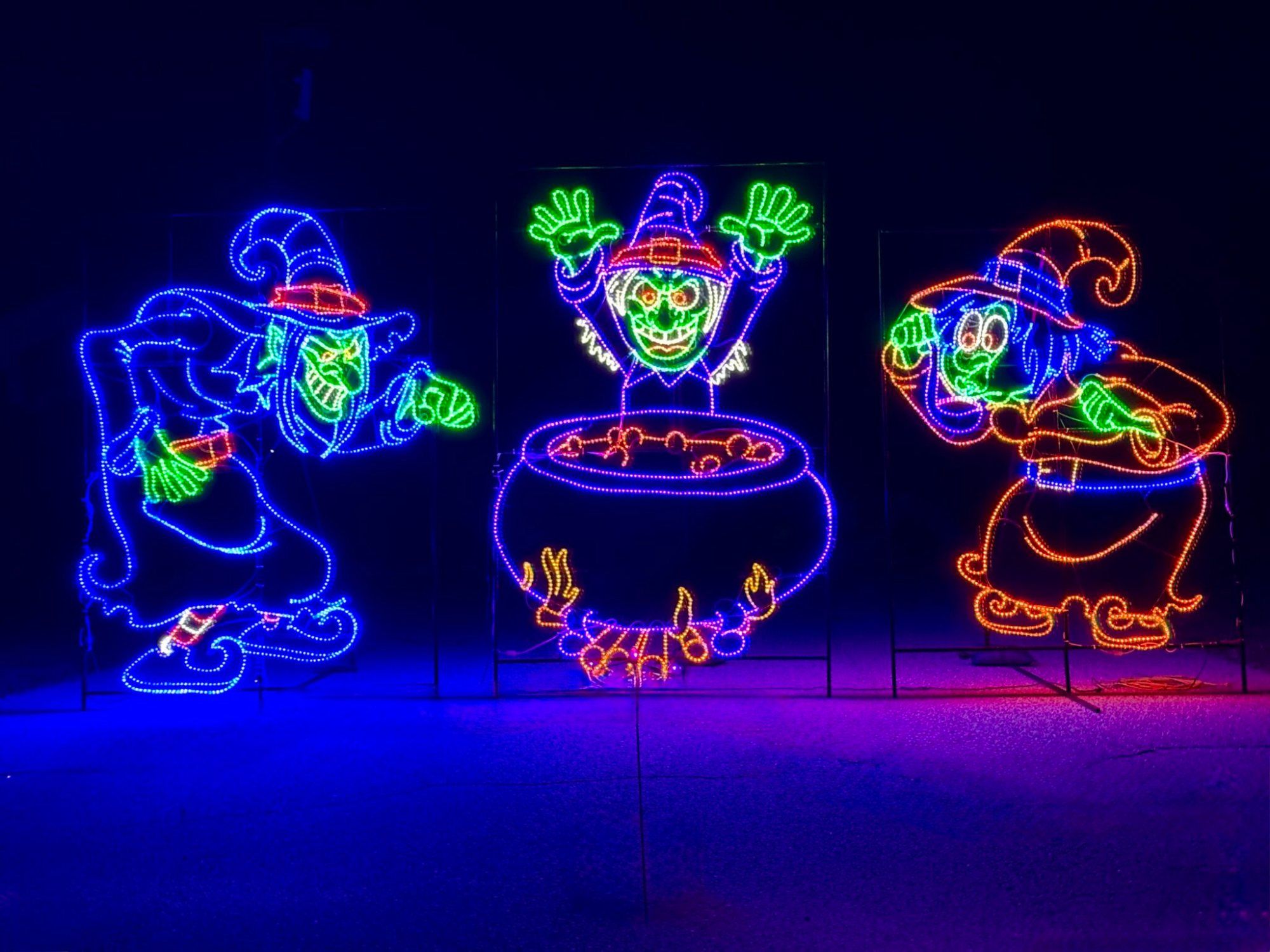Witches stirring a glowing cauldron light display
